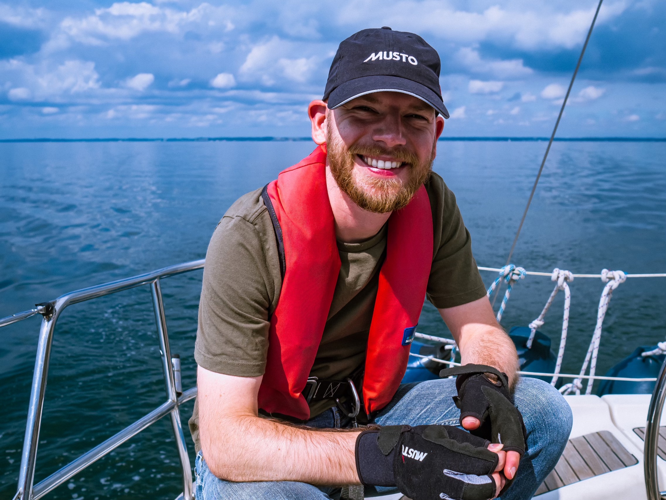 Janis sitting in the cockpit of a sailing boat